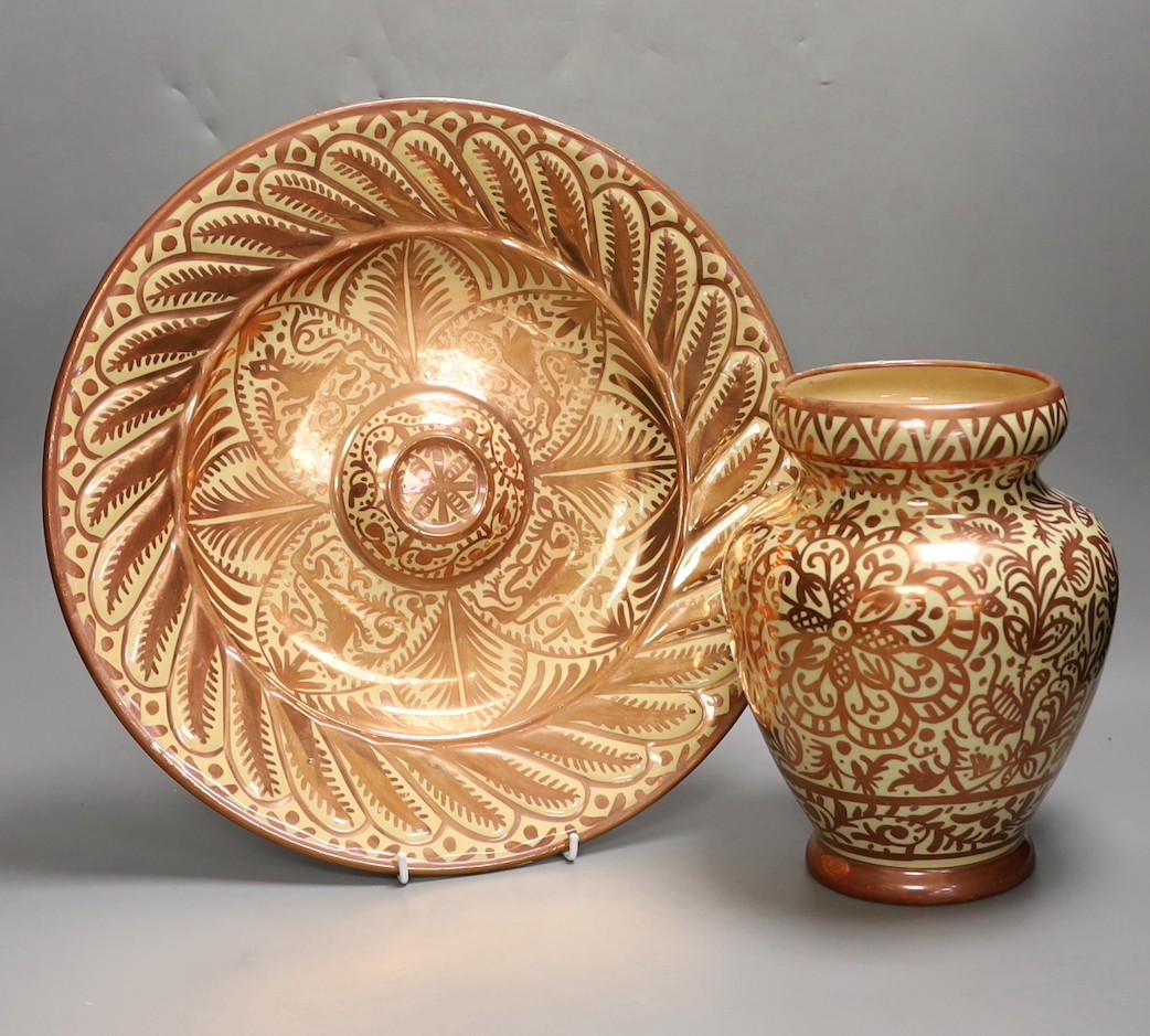 A Hispano Moresque style copper lustre pottery charger and vase, 24cm tall
